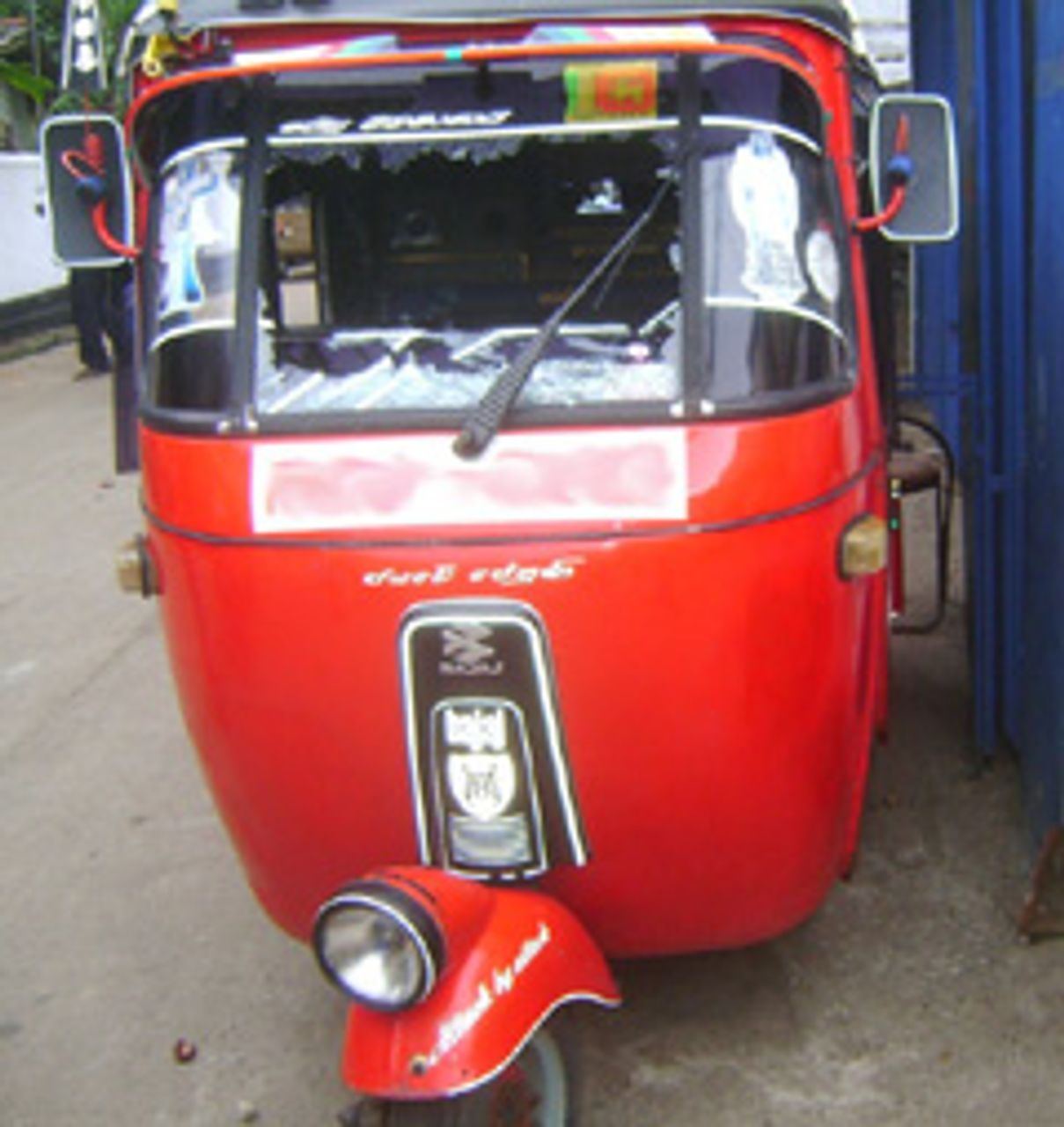 Three-wheeler with smashed windscreen Three-wheeler with smashed windscreen