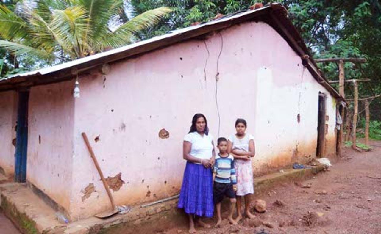 Farming family outside their Welwala home Farming family outside their Welwala home
