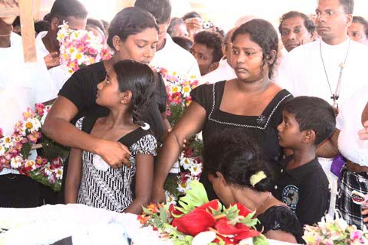 Warnakulasuriya's grieving wife (right) and two children Warnakulasuriya's grieving wife (right) and two children
